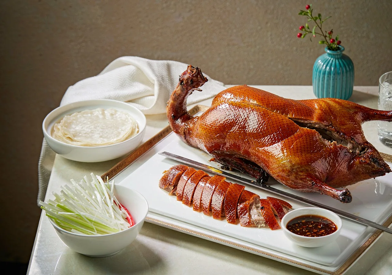 A whole Peking duck served with pancakes and scallions