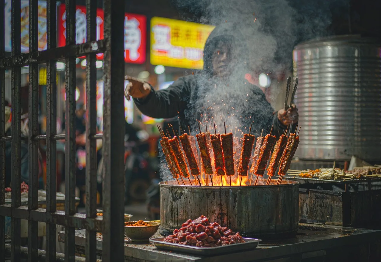 A Chinese night-market stall grilling lamb skewers over coals