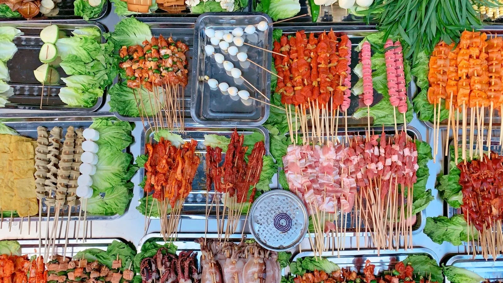 A lively Chinese night market street lined with red lanterns and food stalls