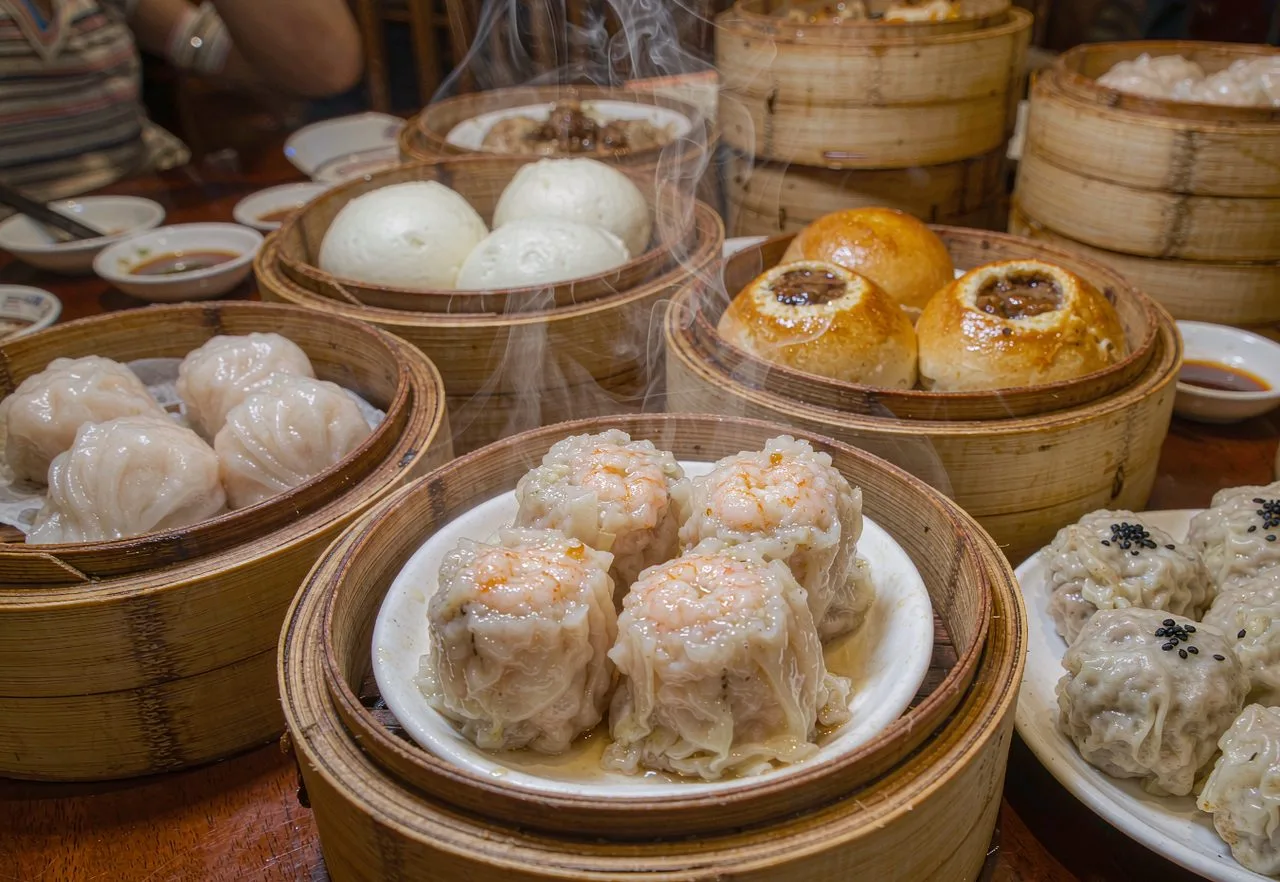 Bamboo steamer baskets of dim sum on a table