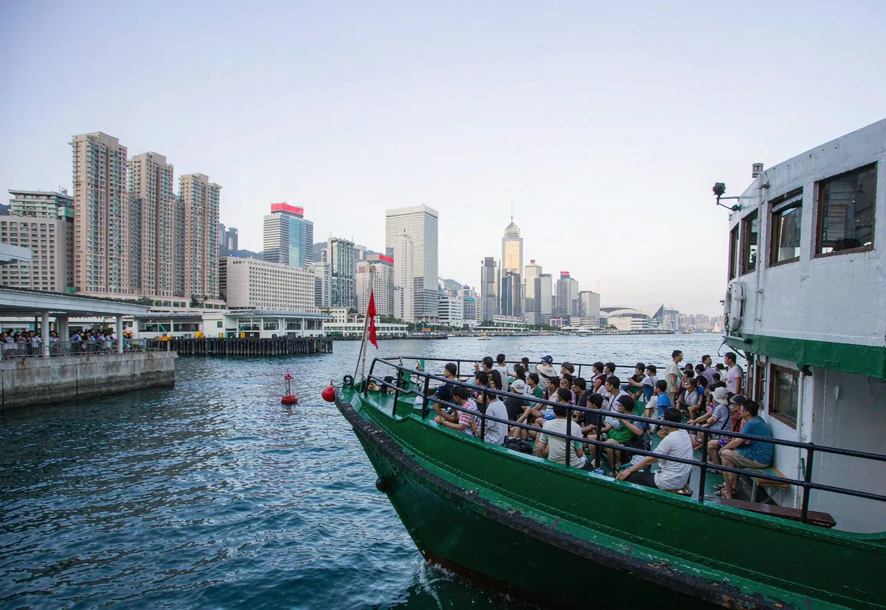 A green-and-white Star Ferry boat crossing Victoria Harbour