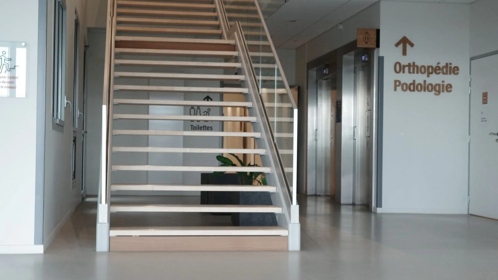 Modern hospital interior with a staircase and elevators