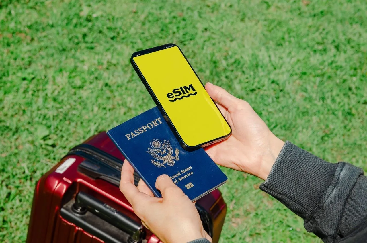 Traveler holding a passport and smartphone with eSIM, ready for real-name registration in China