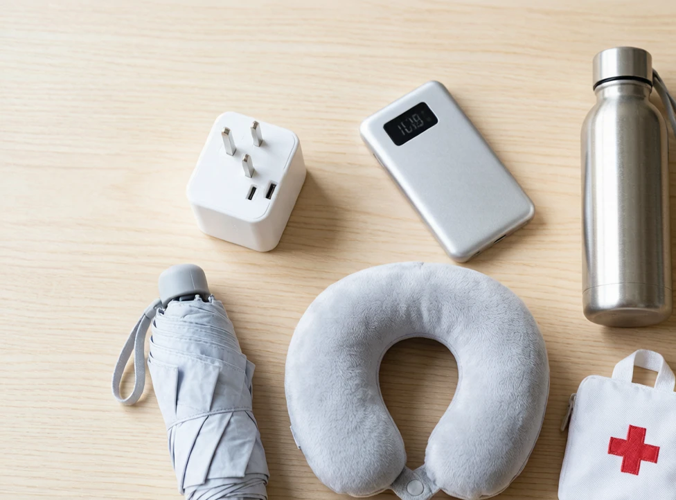 Recommended China travel gear flat lay on a wooden desk