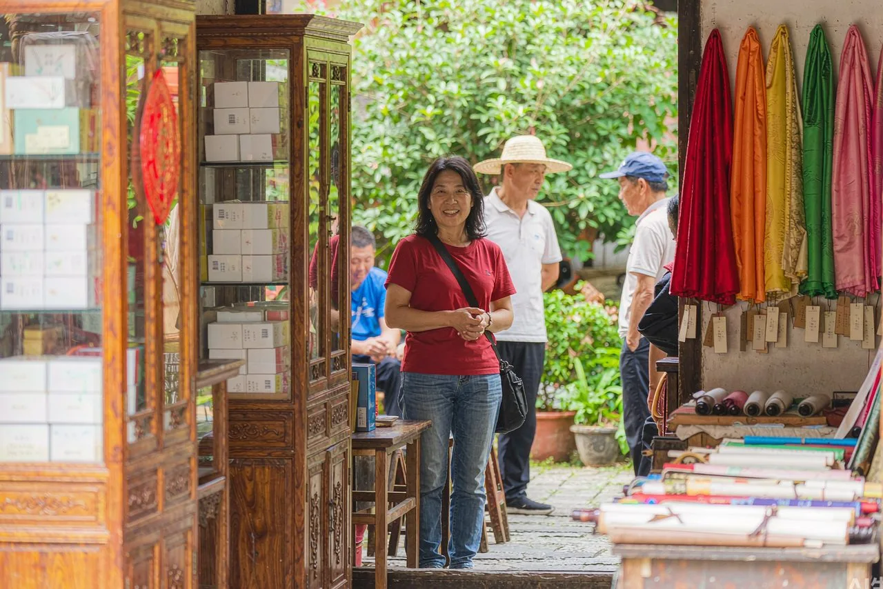 A traditional Chinese tourist market with stalls of silk, tea and souvenirs — haggle politely, buy brands from official stores