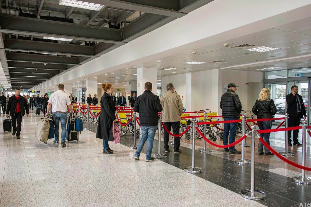 A legitimate taxi stand outside a Chinese airport arrival hall — use the official queue or DiDi, not touts
