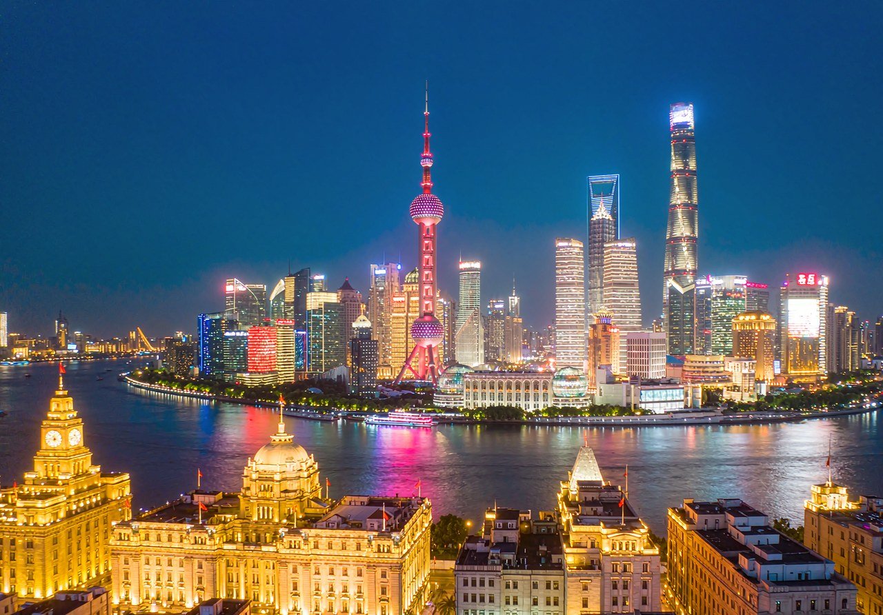 The Bund in Shanghai at dusk, historic buildings and the Pudong skyline across the Huangpu River