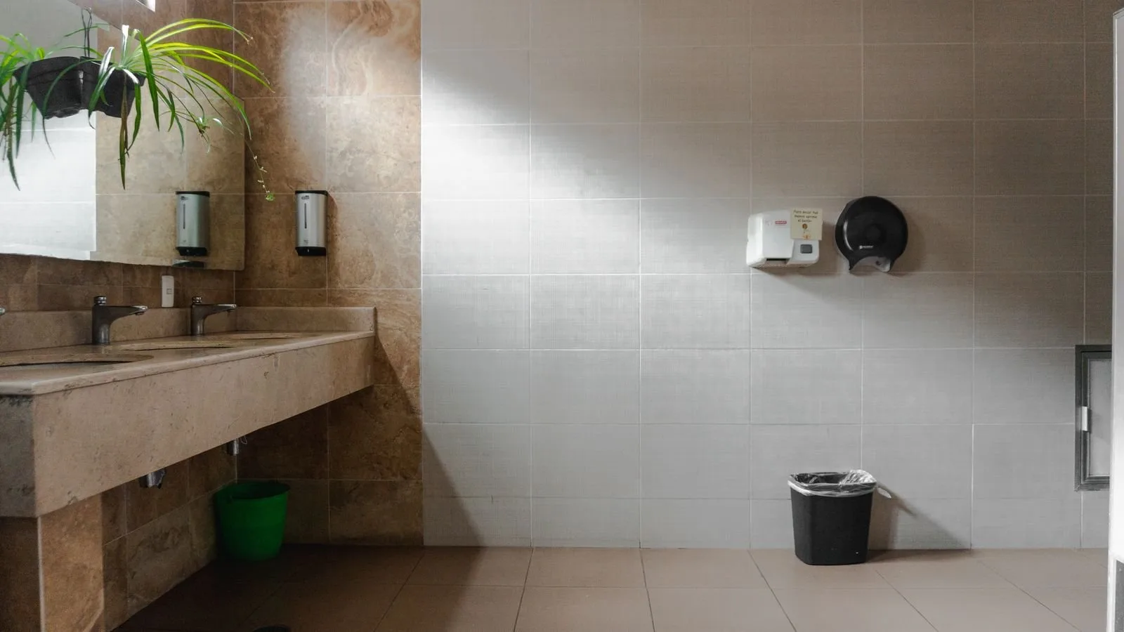 Sinks and a hand dryer in a modern public restroom