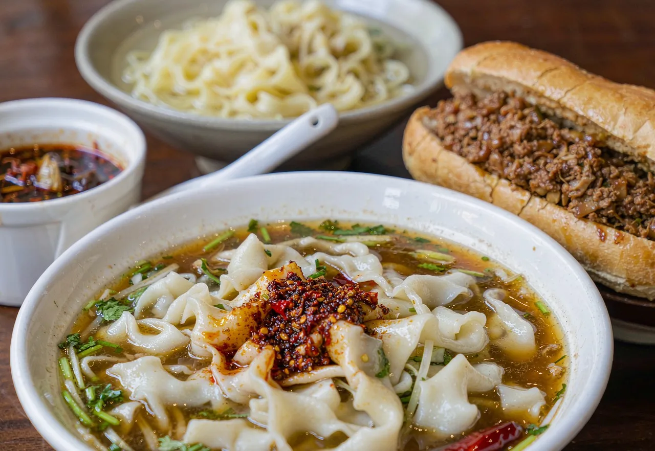 Xi'an biangbiang noodles and roujiamo on a restaurant table