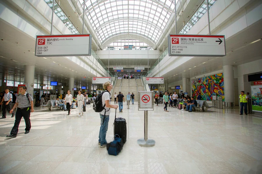 Arriving at a Chinese airport: bilingual signs guide first-time visitors to baggage claim and exit