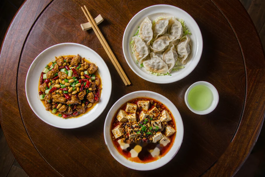 A first meal in China: a typical local restaurant table with shared dishes