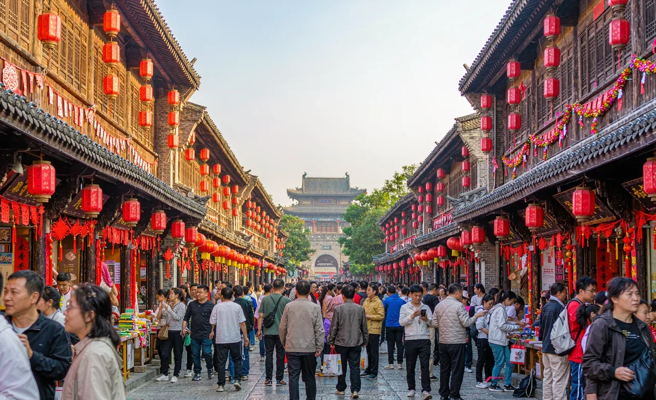 Festive Chinese street decorated with red lanterns and banners during a traditional festival